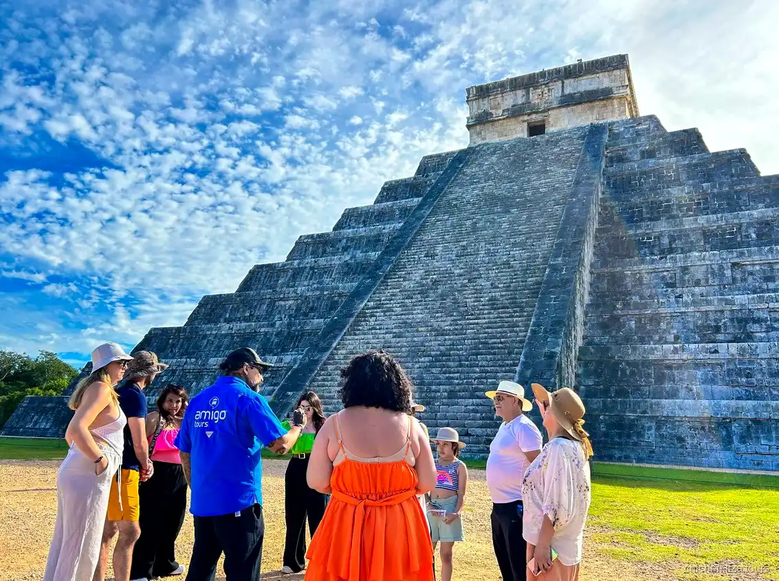Guide leading a group through the Chichen Itza ruins on the Cancun day tour